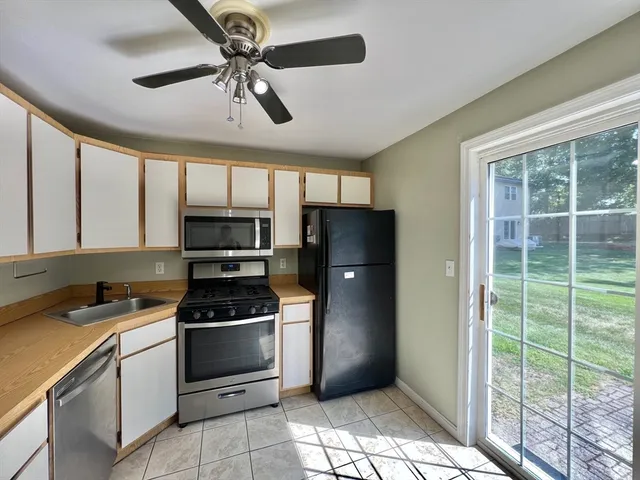 a kitchen with stainless steel appliances a stove a refrigerator and cabinets