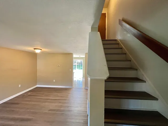 wooden floor in an empty room with a fan