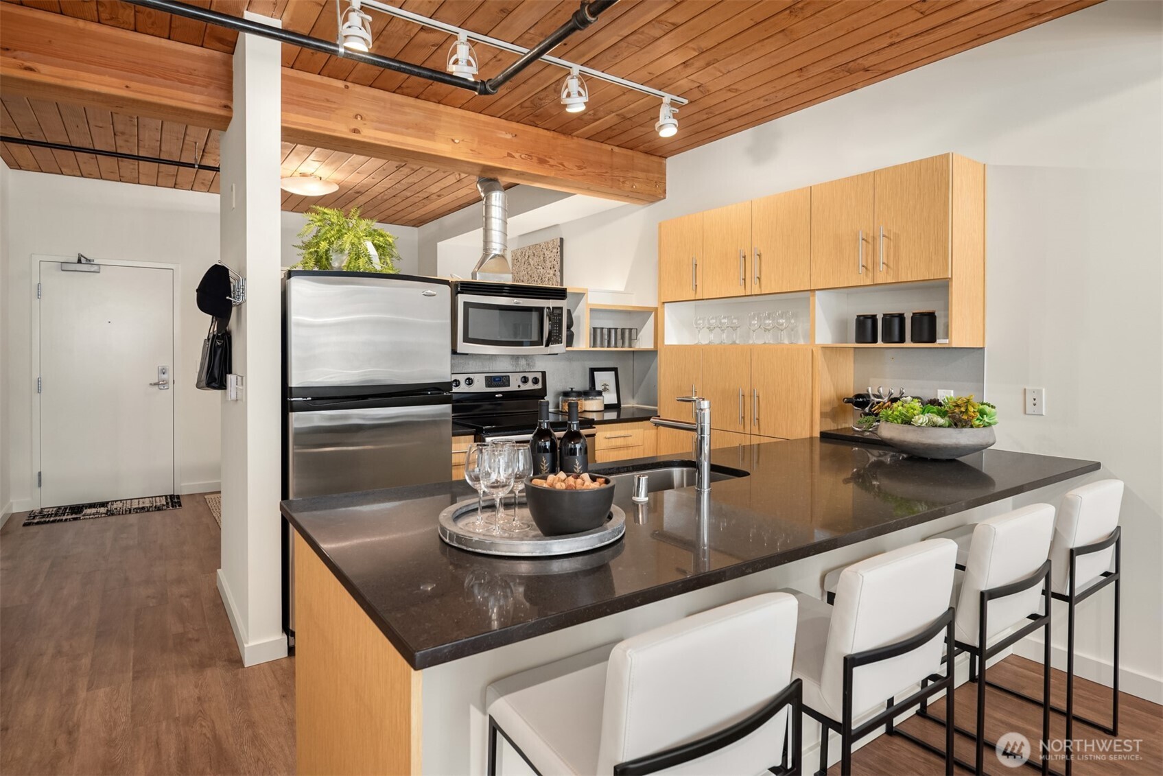 401 9th Avenue North, Unit 210 Seattle, WA 98109 - Photo 11 of 30 a kitchen with a table chairs and refrigerator