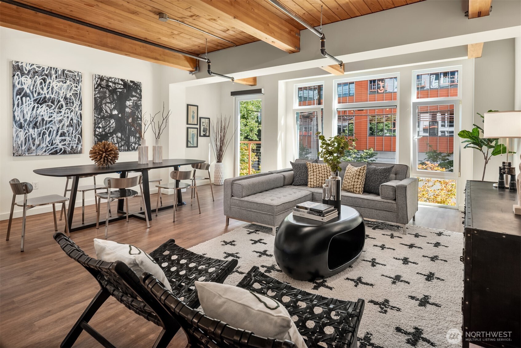 401 9th Avenue North, Unit 210 Seattle, WA 98109 - Photo 15 of 30 a living room with furniture a flat screen tv and a floor to ceiling window
