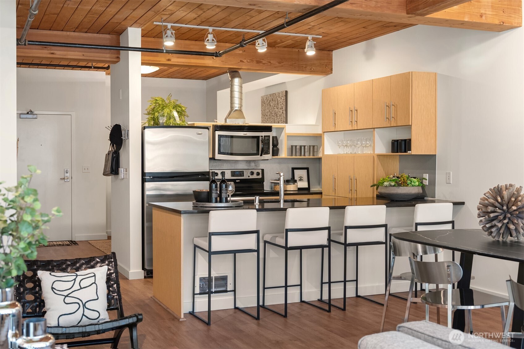 401 9th Avenue North, Unit 210 Seattle, WA 98109 - Photo 20 of 30 a kitchen with stainless steel appliances kitchen island granite countertop a refrigerator a stove top oven a sink and dishwasher