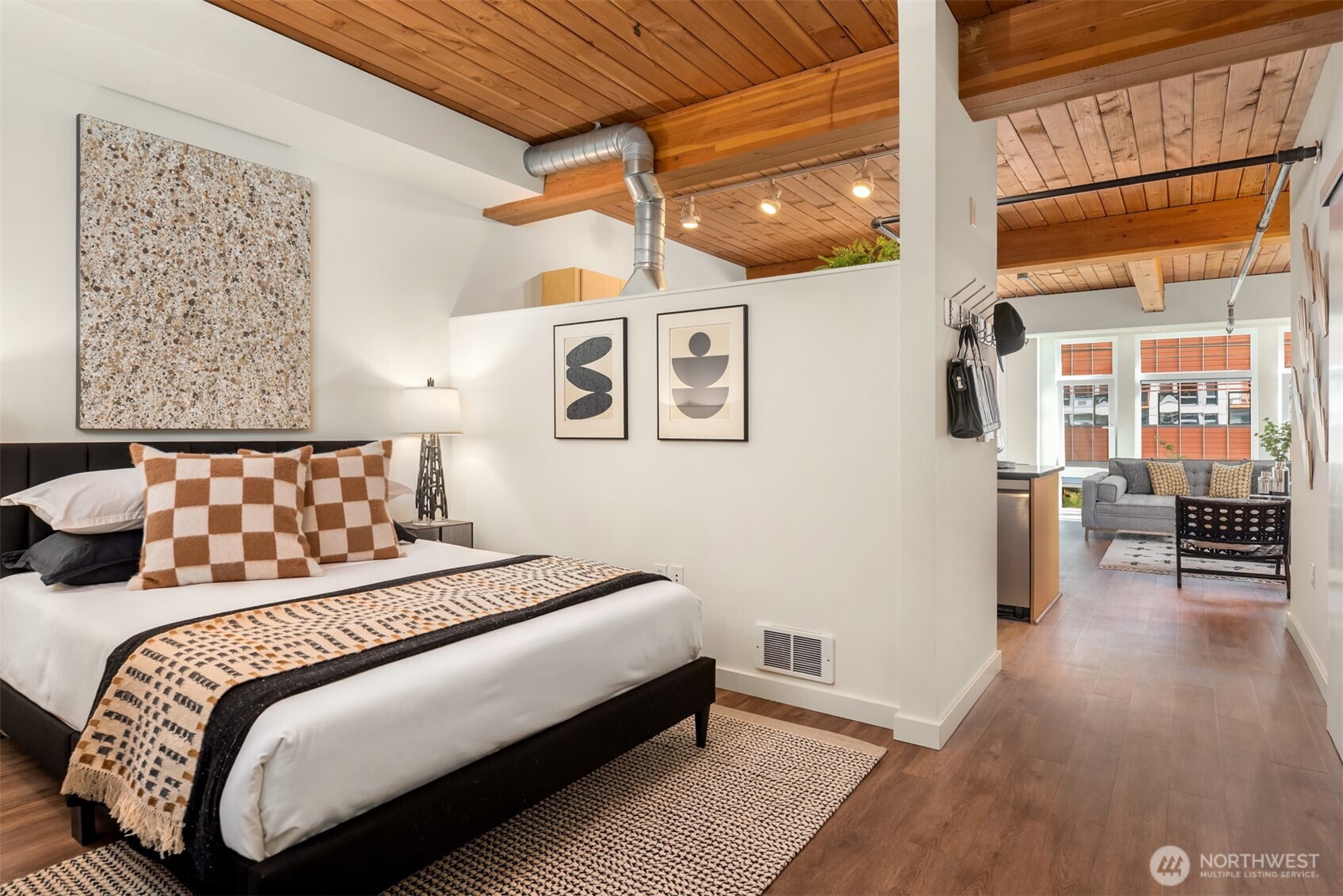 401 9th Avenue North, Unit 210 Seattle, WA 98109 - Photo 8 of 30 a bedroom with a large bed and a wooden floor