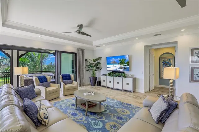 a living room with furniture a large window and a flat screen tv