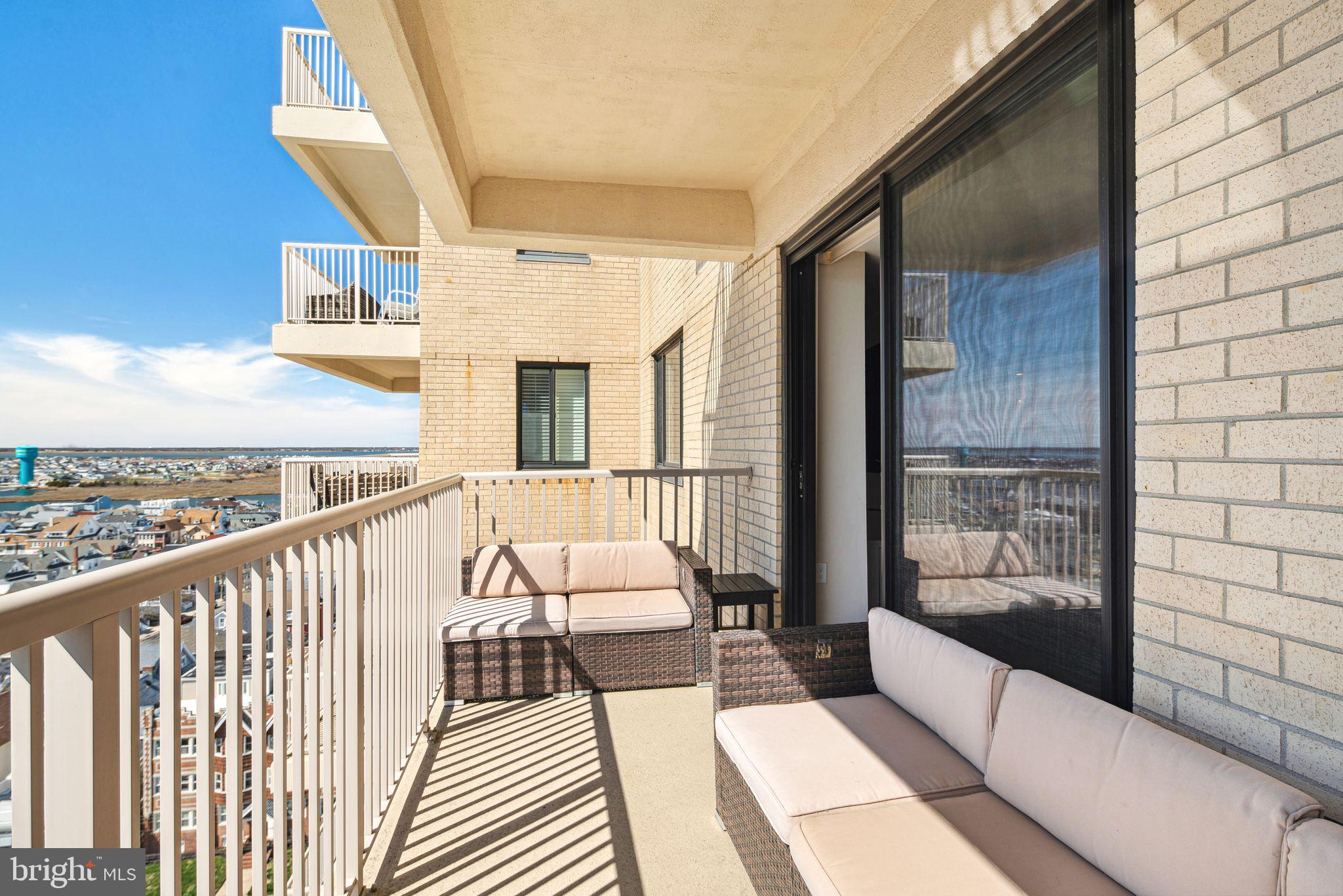 5000 Boardwalk Ventnor City, NJ 08406 - Photo 14 of 44 a balcony with wooden floor table and chairs