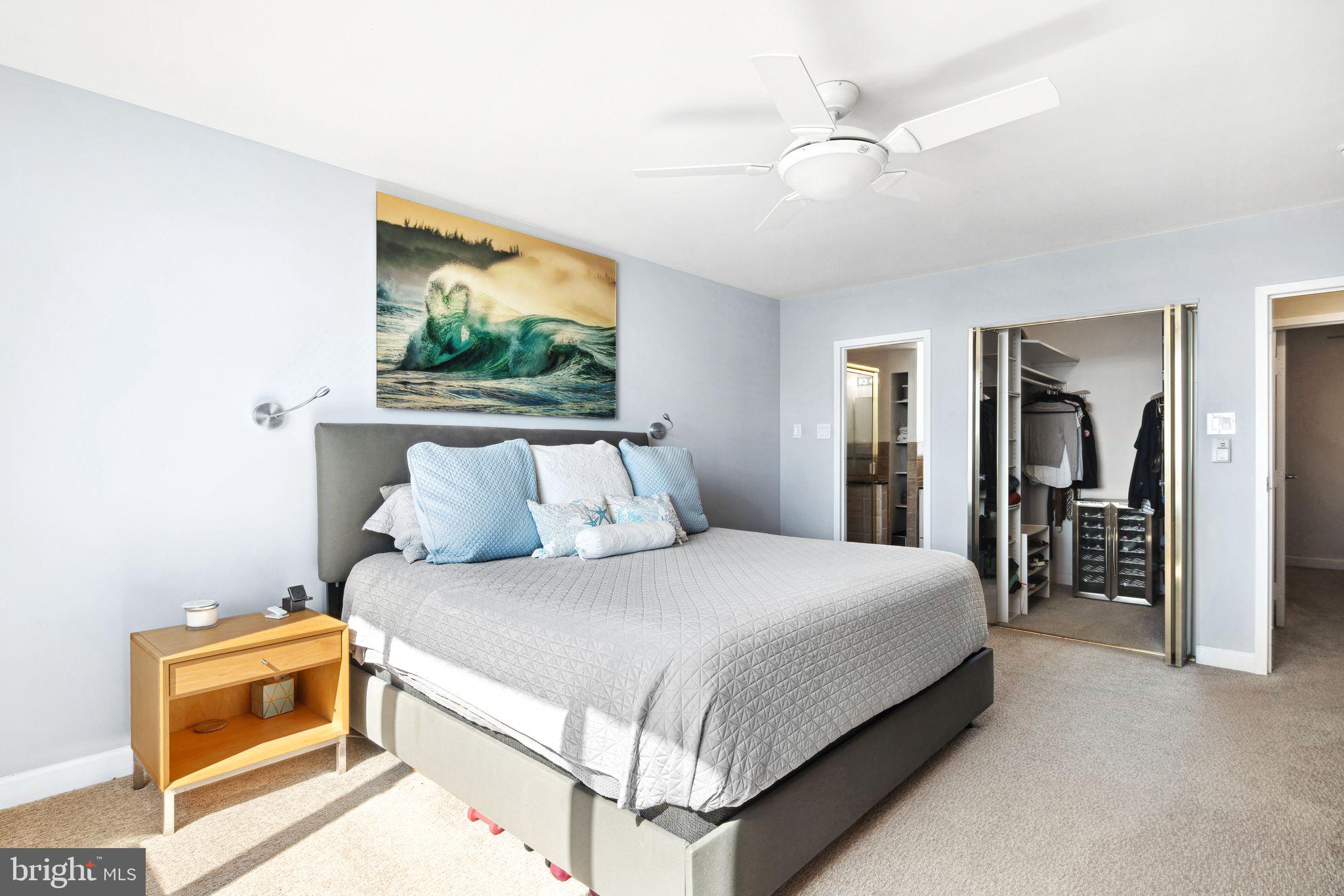 5000 Boardwalk Ventnor City, NJ 08406 - Photo 20 of 44 a bedroom with a large bed and a chandelier