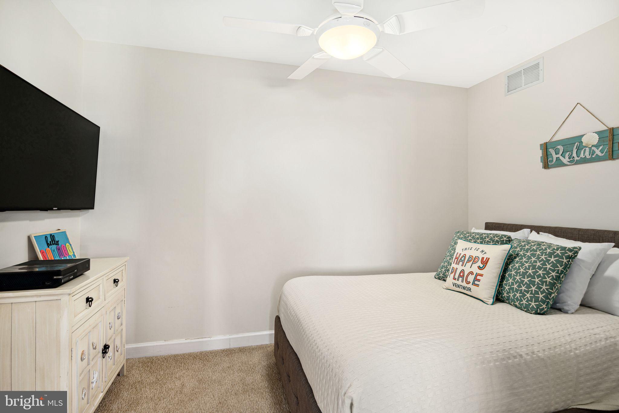 5000 Boardwalk Ventnor City, NJ 08406 - Photo 24 of 44 a bedroom with a bed and a flat screen tv