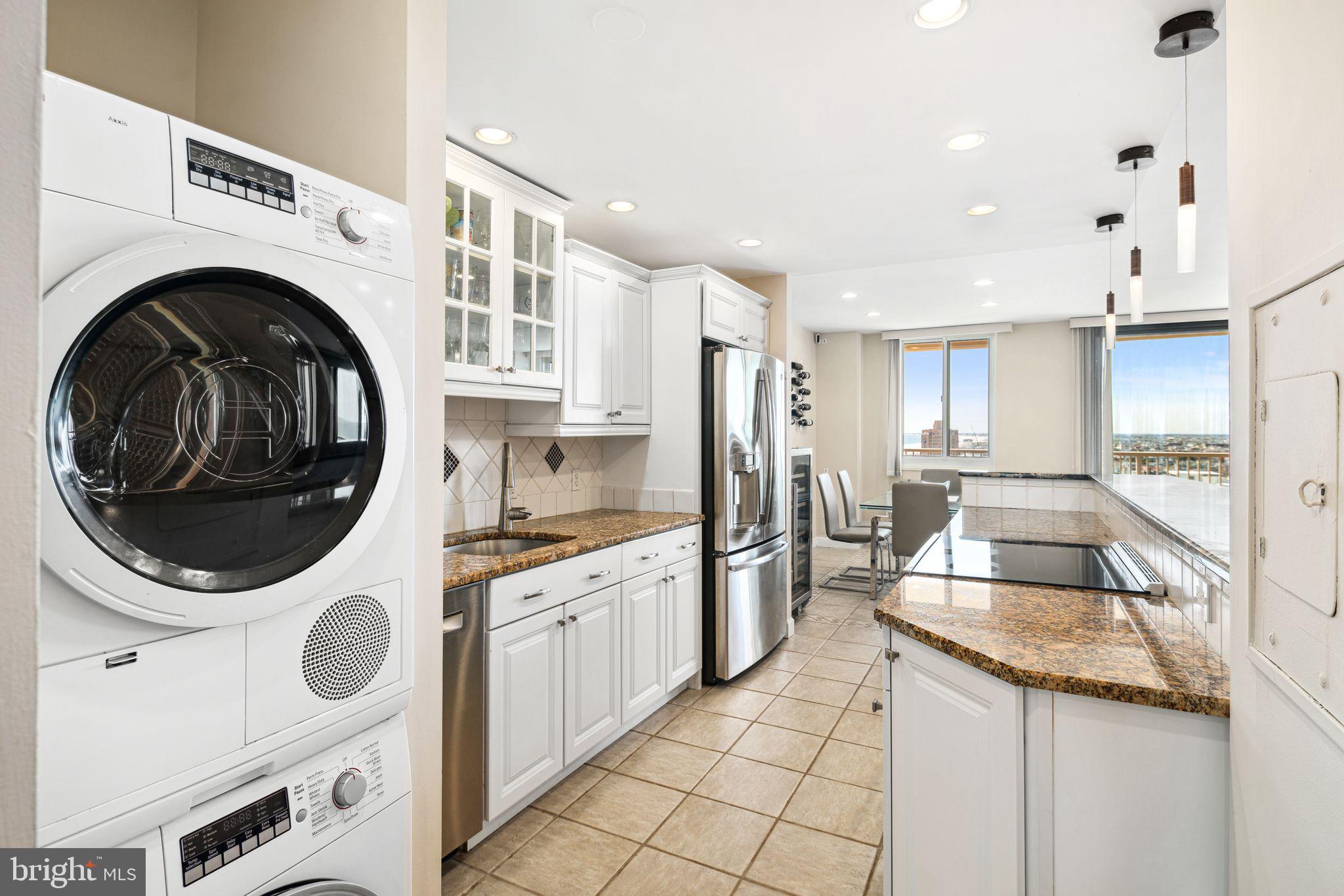 5000 Boardwalk Ventnor City, NJ 08406 - Photo 6 of 44 a kitchen with granite countertop a sink a stove and cabinets