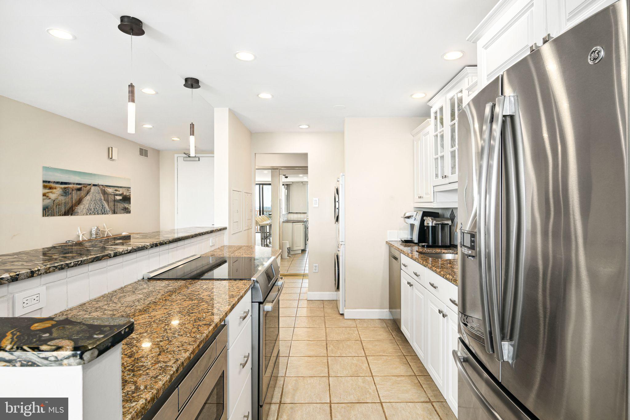 5000 Boardwalk Ventnor City, NJ 08406 - Photo 8 of 44 a kitchen with granite countertop a sink stove and refrigerator