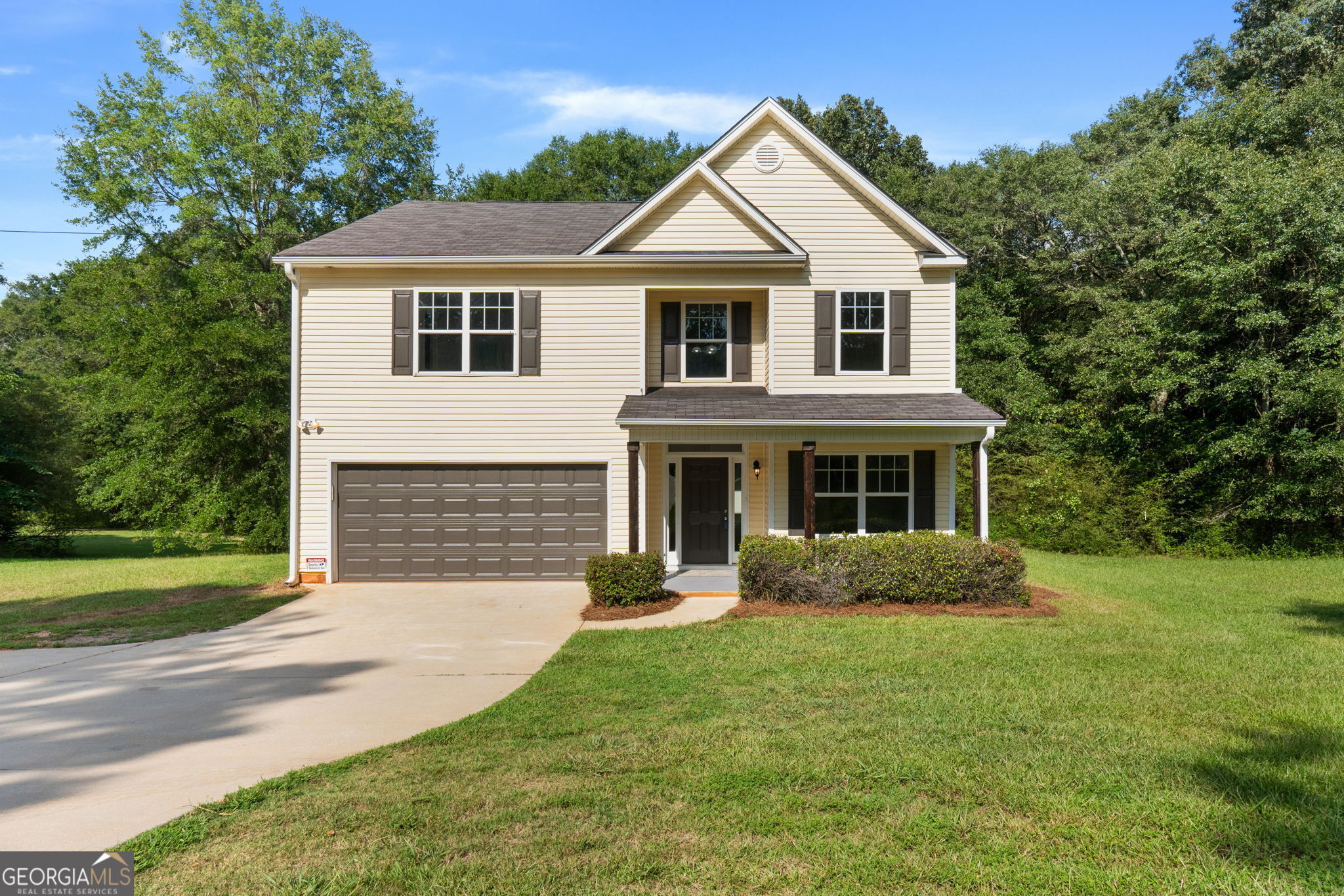 1953 Old Jackson Road Locust Grove, GA 30248 - Photo 1 of 1 a front view of a house with a yard and trees