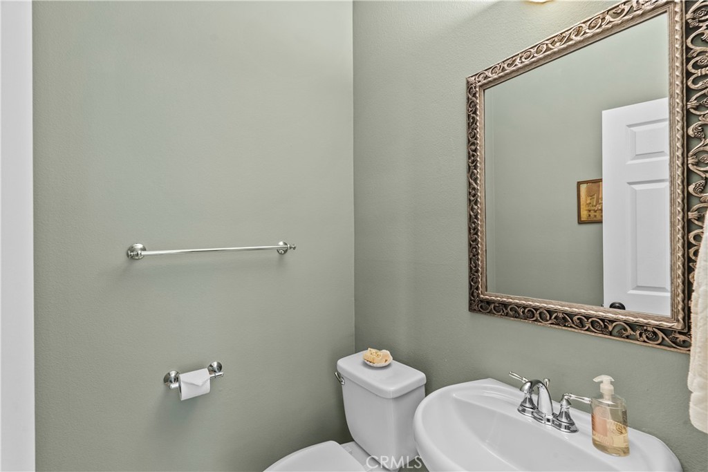 28409 Connick Place Saugus, CA 91350 - Photo 27 of 66 a bathroom with a toilet a sink and mirror