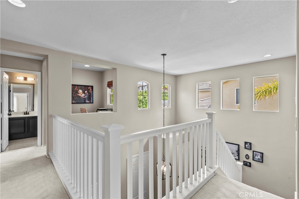 28409 Connick Place Saugus, CA 91350 - Photo 30 of 66 a view of a hallway to a livingroom with wooden floor and windows