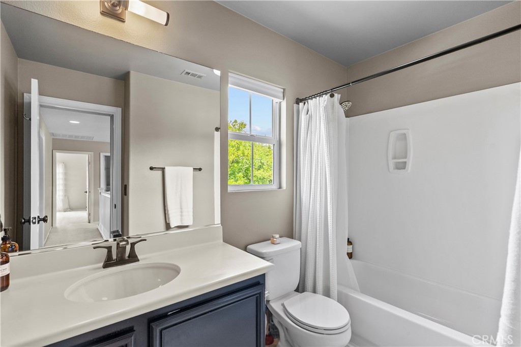 28409 Connick Place Saugus, CA 91350 - Photo 43 of 66 a bathroom with a sink a toilet a window and shower