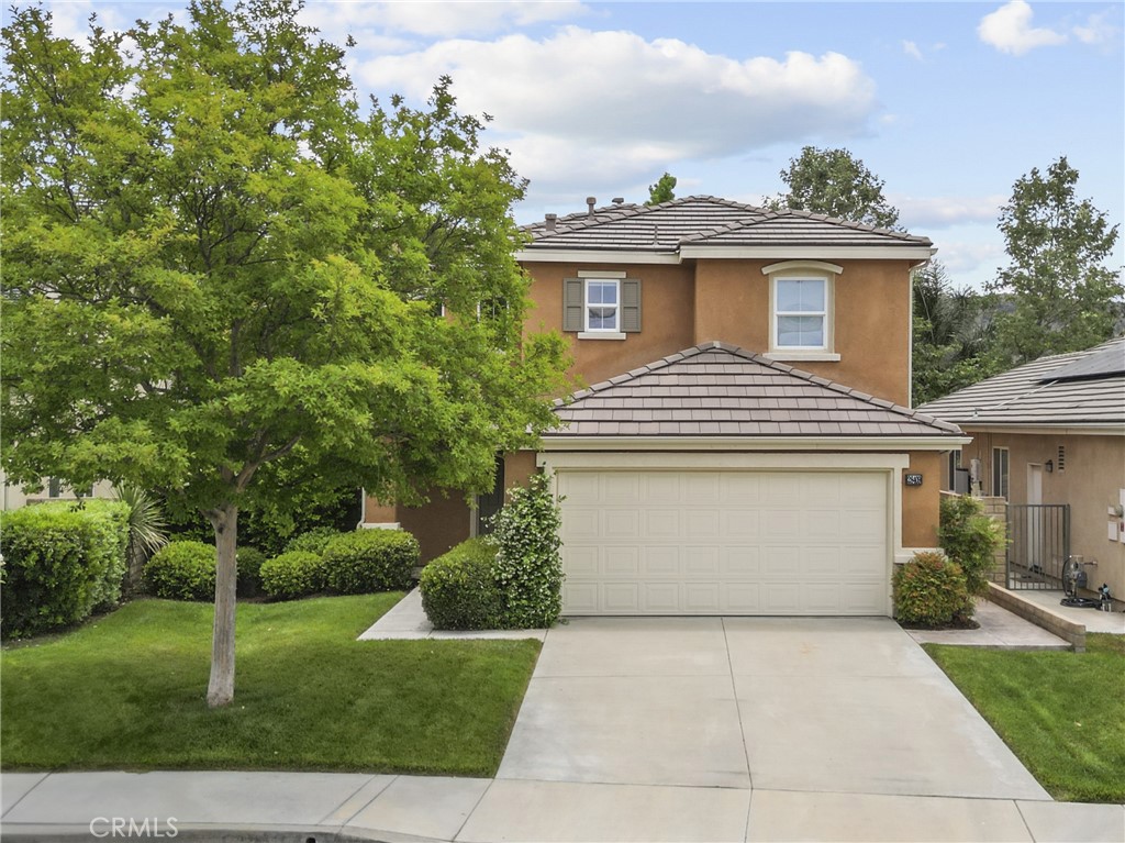 28409 Connick Place Saugus, CA 91350 - Photo 56 of 66 a view of a white house with a yard plants and large tree