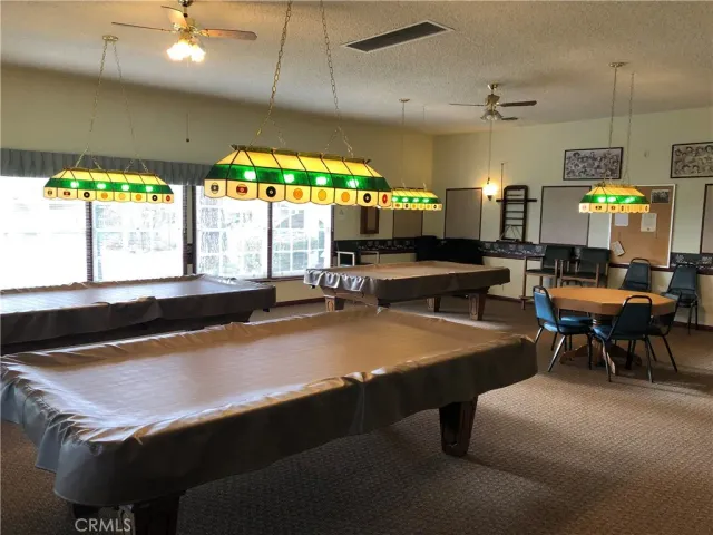 a view of a dining room with furniture a chandelier and wooden floor