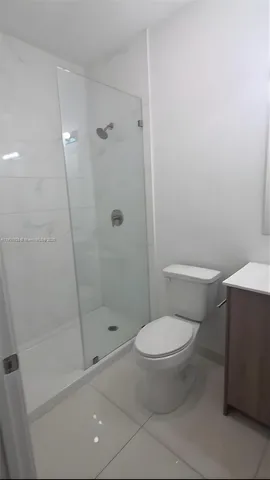 a white toilet sitting next to a bath tub