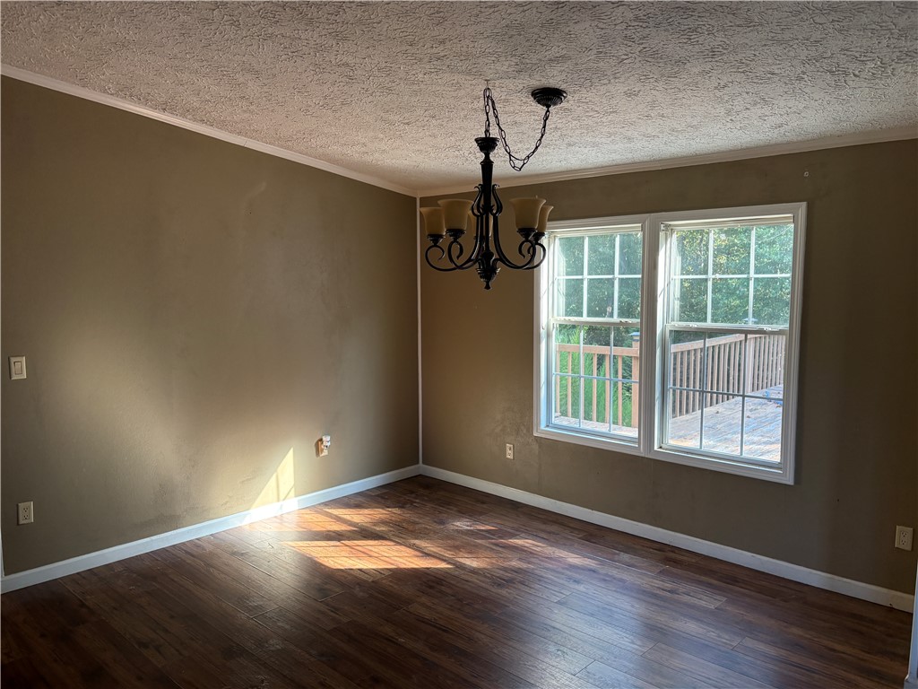 1108 Trotter Road Anderson, SC 29626 - Photo 8 of 27 Gleaming hardwood floors and a classic chandelier anchor this inviting dining space.