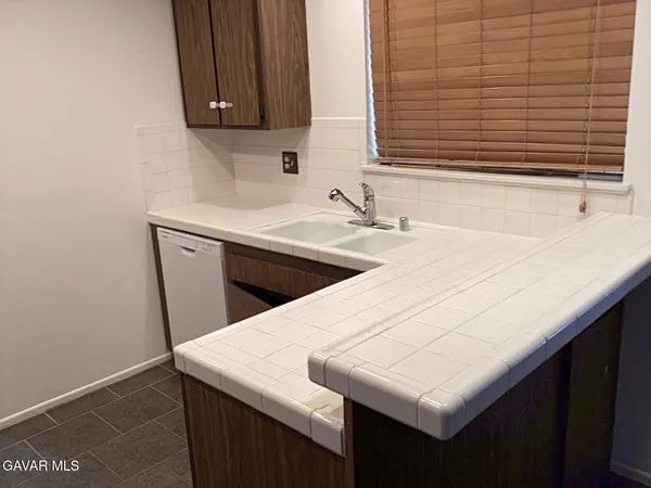 a kitchen with a sink a cabinets and window