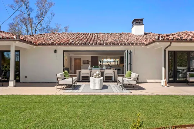 a view of a patio with table and chairs and potted plants