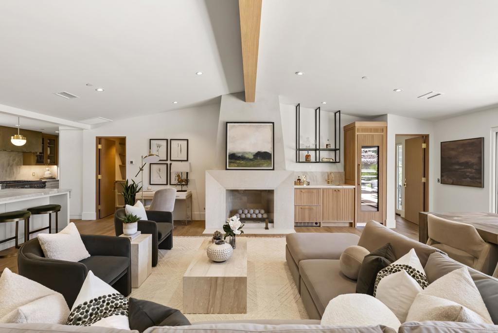 5927 Linea Del Cielo, Unit ELM Rancho Santa Fe, CA 92067 - Photo 2 of 20 a living room with furniture fireplace and a large window