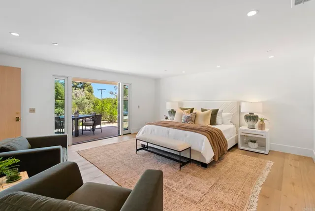 a spacious bedroom with a bed and a couch