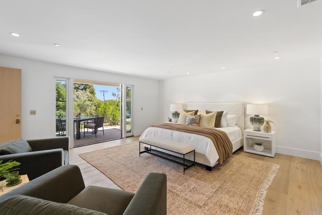 5927 Linea Del Cielo, Unit ELM Rancho Santa Fe, CA 92067 - Photo 10 of 20 a spacious bedroom with a bed and a couch