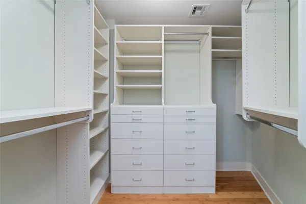 a view of walk in closet with empty racks