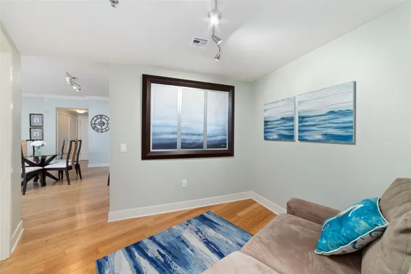 a bedroom with furniture and a wooden floor