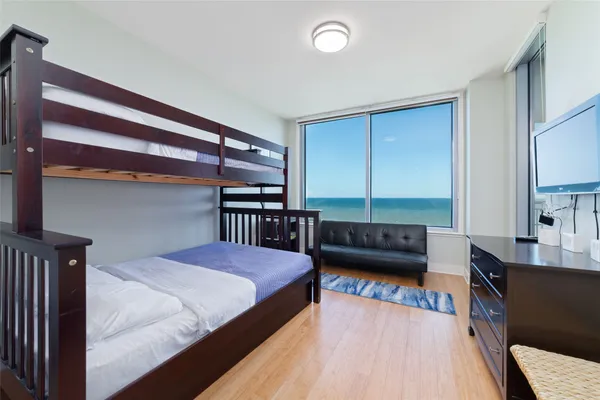 a bedroom with a bed and a television