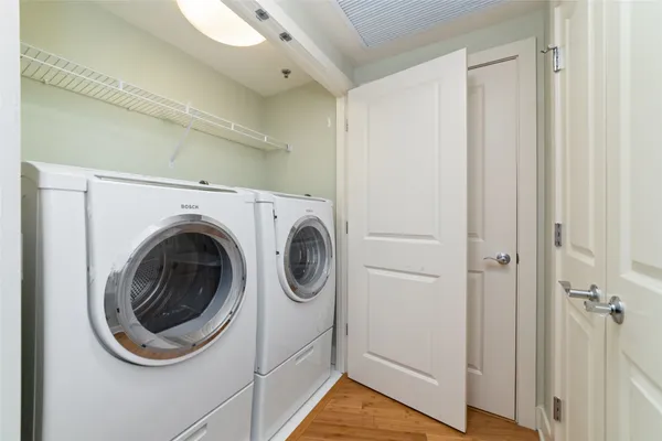 a view of a hallway with washer and dryer