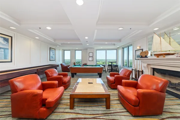 a living room with furniture pool table and a flat screen tv