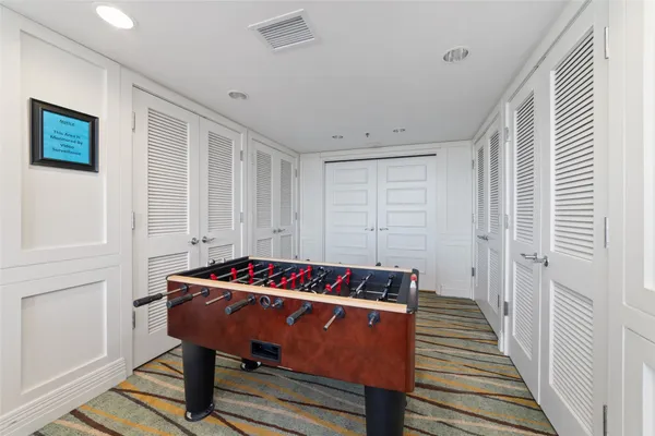 a living room with furniture two night stand and a flat screen tv