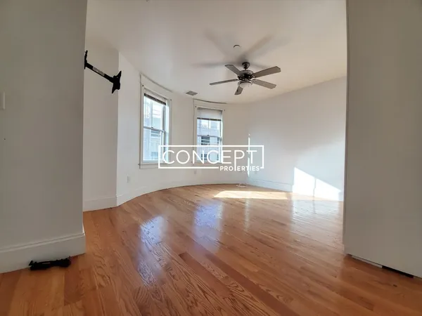 a view of a kitchen with wooden floor and a ceiling fan