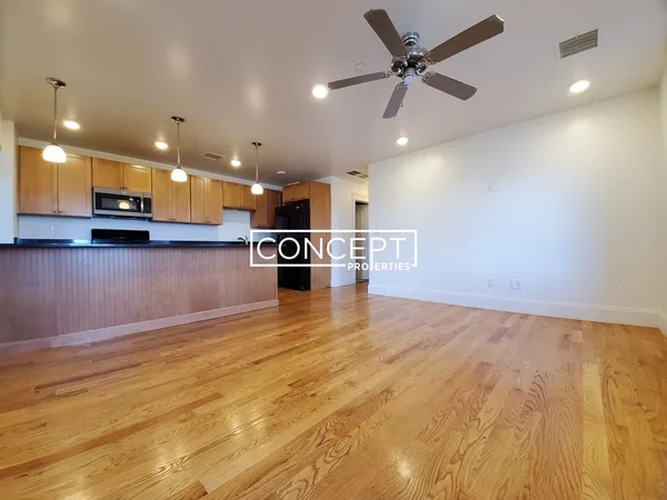 a view of kitchen with microwave and refrigerator