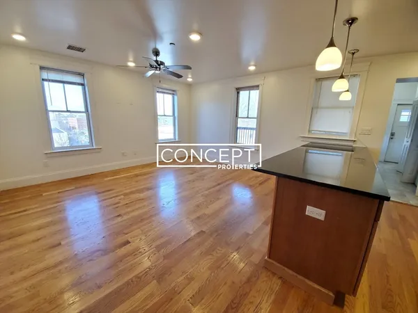 a view of a kitchen area with wooden floor