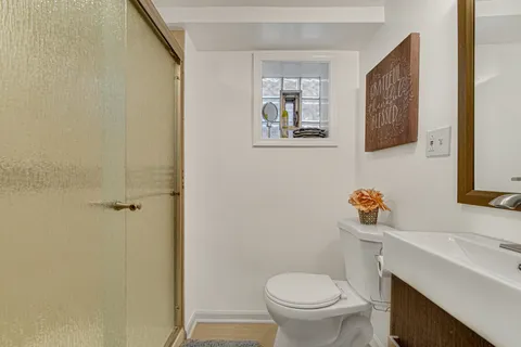 a bathroom with a sink toilet and vanity