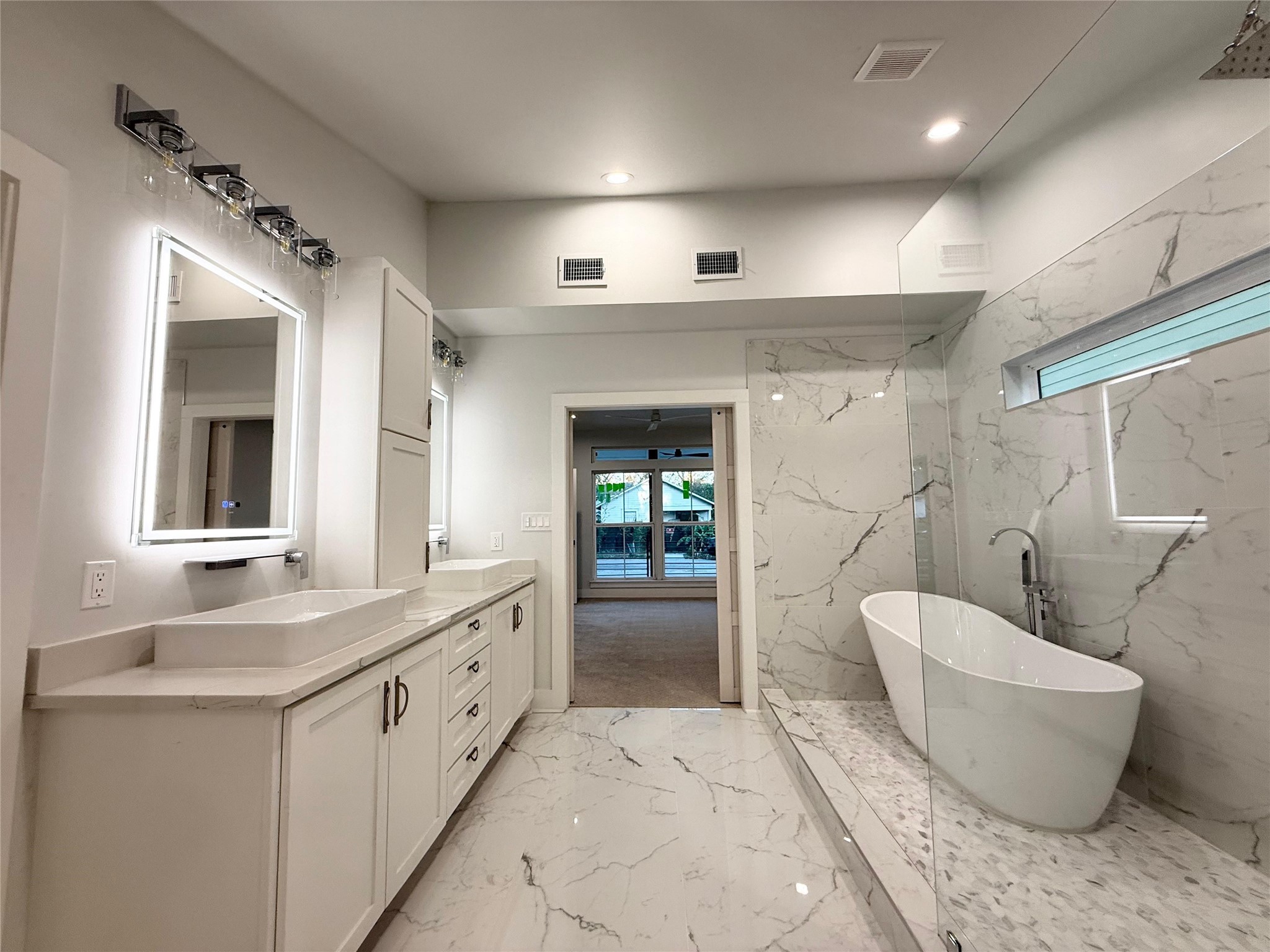 1617 Common Street Houston, TX 77009 - Photo 18 of 50 a spacious bathroom with a granite countertop sink and mirror