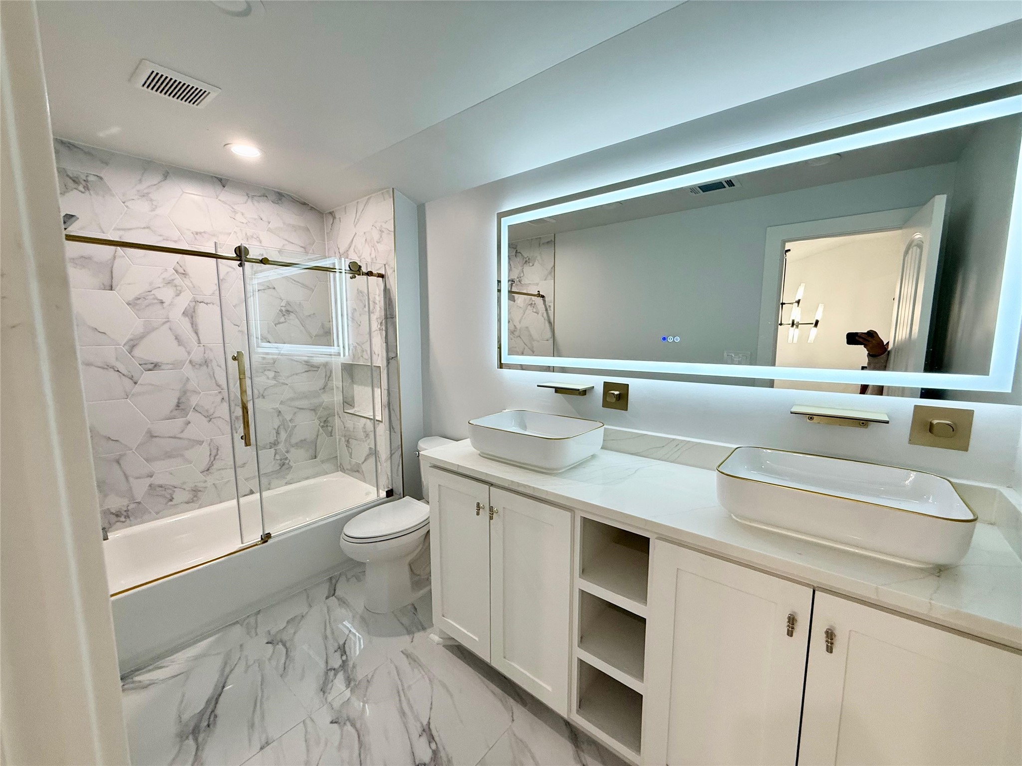 1617 Common Street Houston, TX 77009 - Photo 27 of 50 a bathroom with a double vanity sink toilet and shower