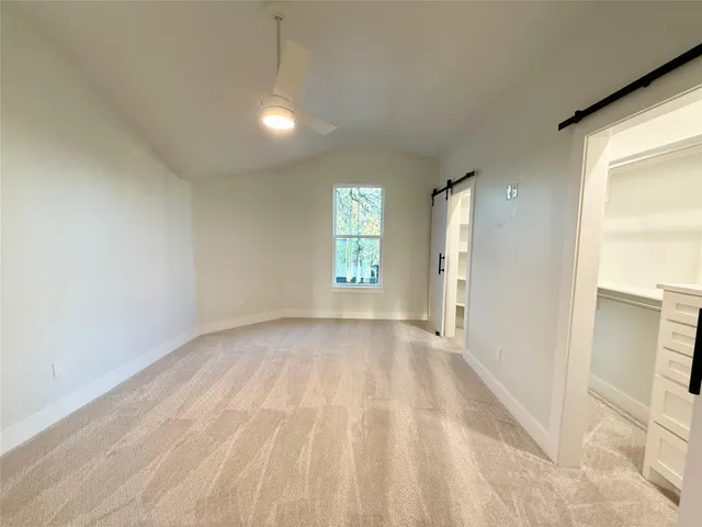 an empty room with windows and city view