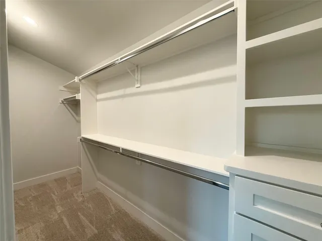 a view of a room with wooden floor and windows