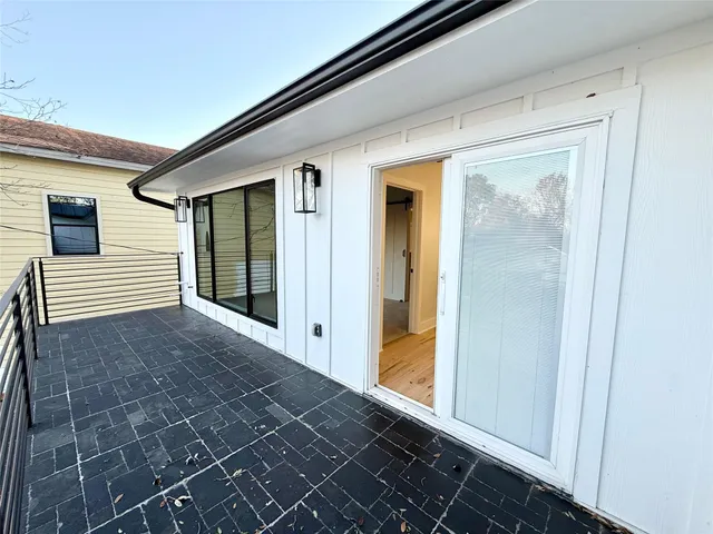 a view of a white house with a yard