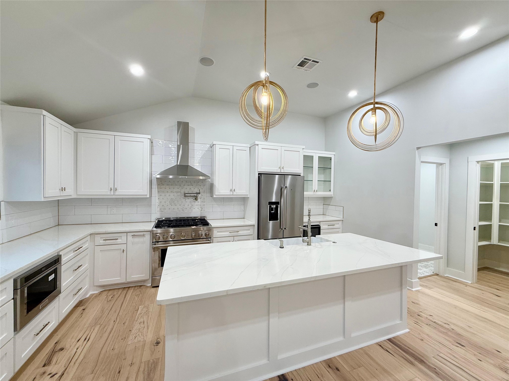 1617 Common Street Houston, TX 77009 - Photo 42 of 50 a kitchen with a refrigerator a stove cabinets dining table and chairs