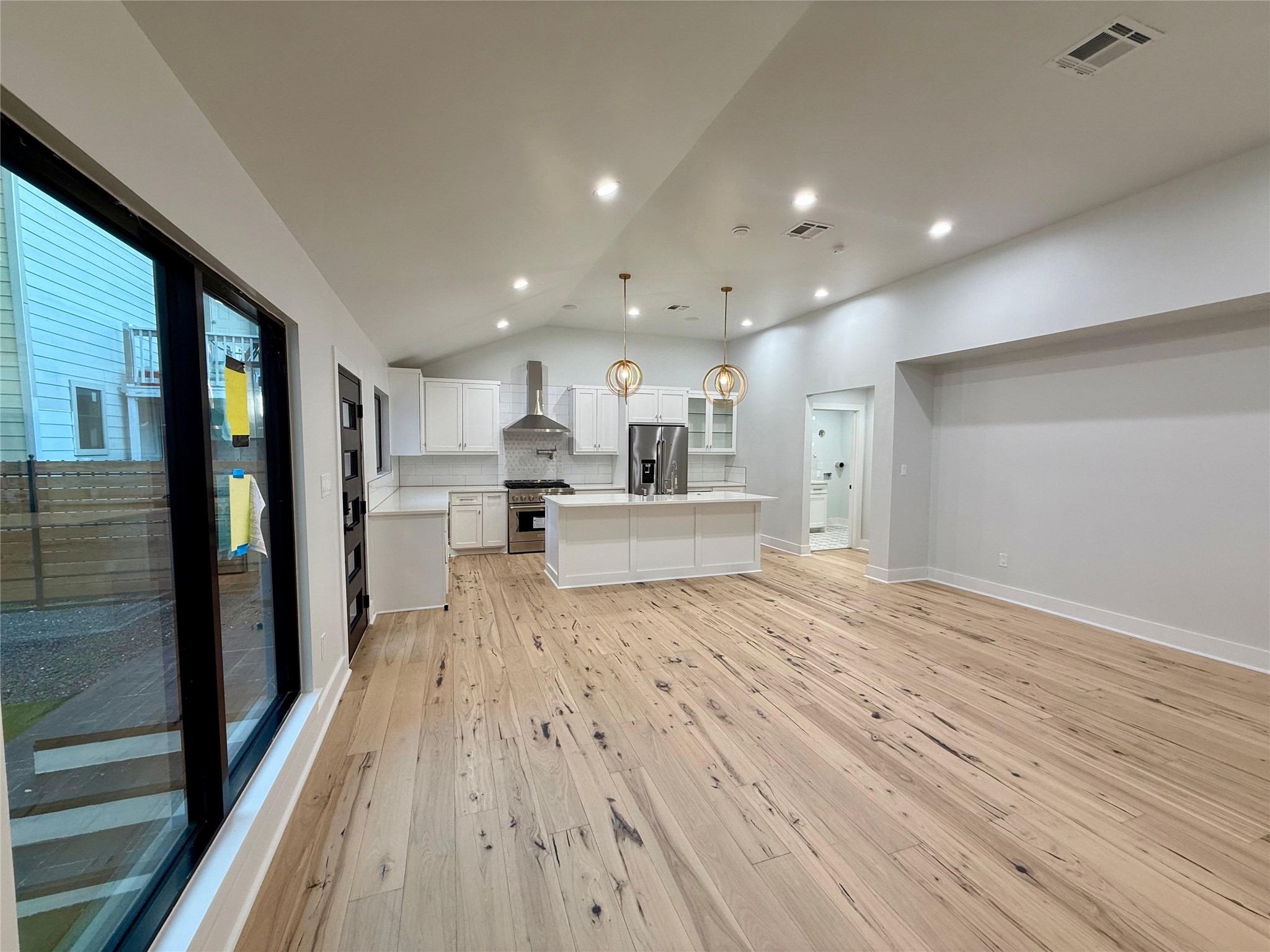 1617 Common Street Houston, TX 77009 - Photo 43 of 50 a view of a kitchen with kitchen island wooden floors stainless steel appliances
