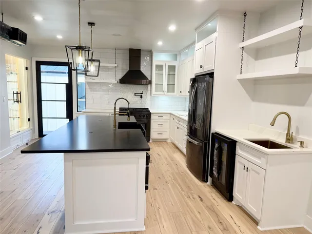 a kitchen with stainless steel appliances a stove and a refrigerator