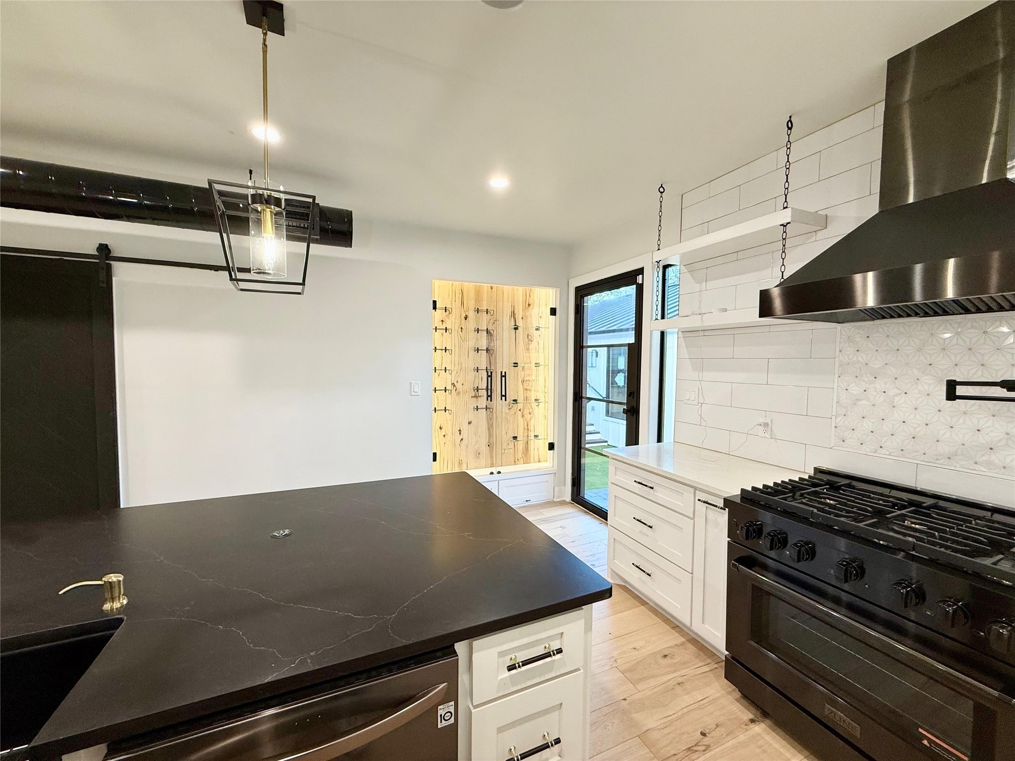 1617 Common Street Houston, TX 77009 - Photo 10 of 50 a kitchen with stainless steel appliances and wooden floor