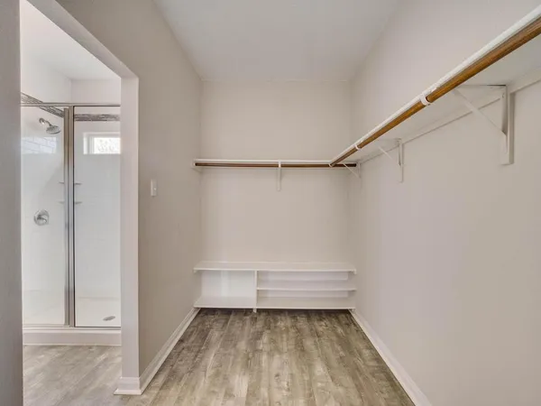 a bathroom with a sink toilet vanity and shower