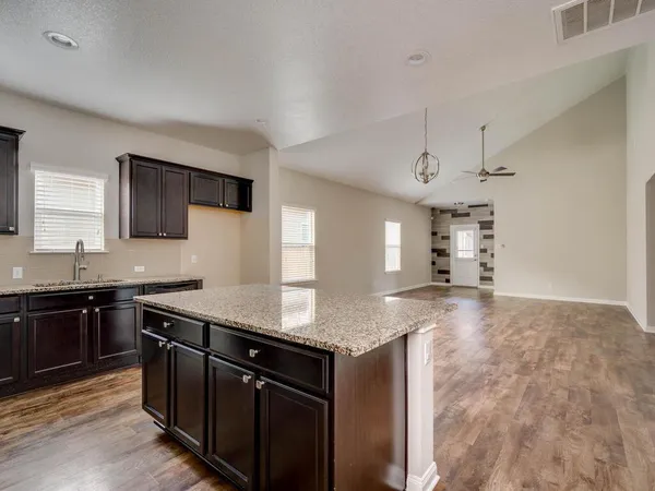 a kitchen with stainless steel appliances granite countertop a sink stove and cabinets