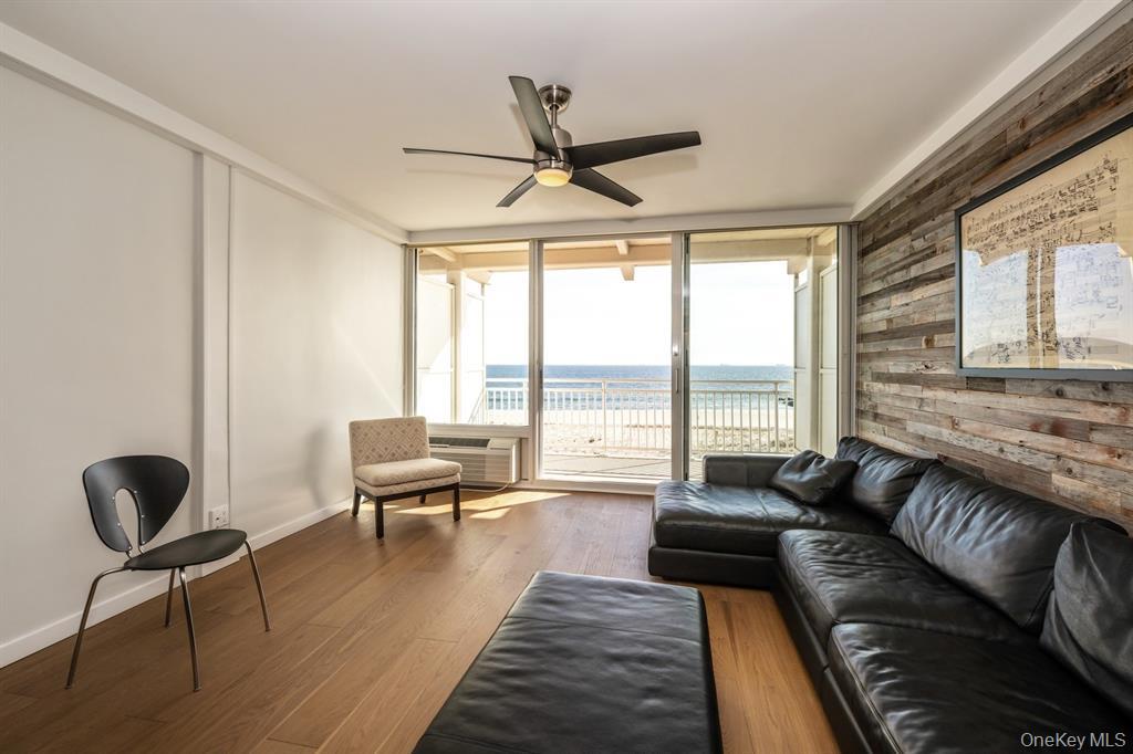 830 Shore Road, Unit 4Q Long Beach, NY 11561 - Photo 12 of 26 a living room with furniture and a large window