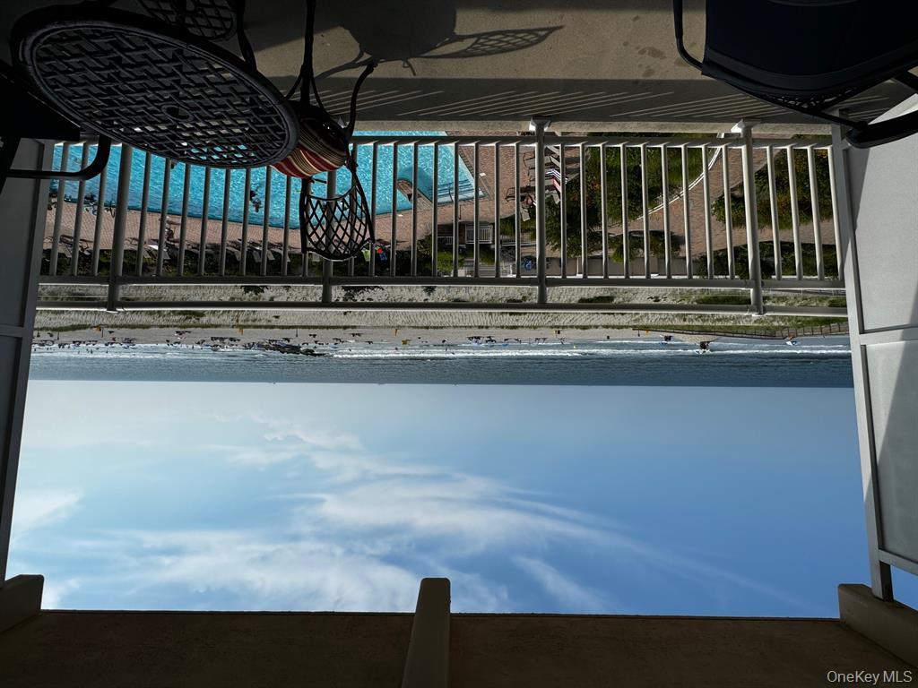 830 Shore Road, Unit 4Q Long Beach, NY 11561 - Photo 16 of 26 a view of a balcony with chair and wooden floor