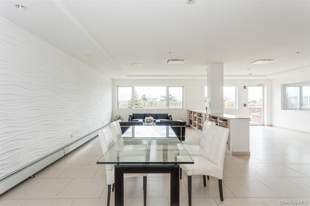 830 Shore Road, Unit 4Q Long Beach, NY 11561 - Photo 23 of 26 a view of a dining room with furniture and wooden floor