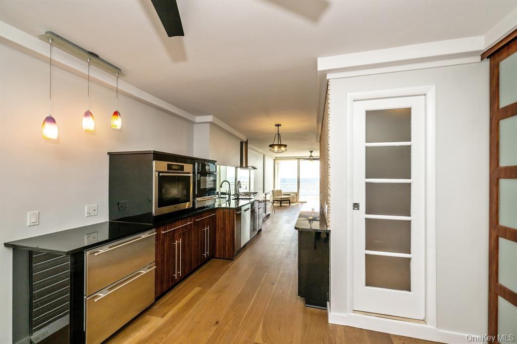 830 Shore Road, Unit 4Q Long Beach, NY 11561 - Photo 7 of 26 a living room with stainless steel appliances furniture and a flat screen tv